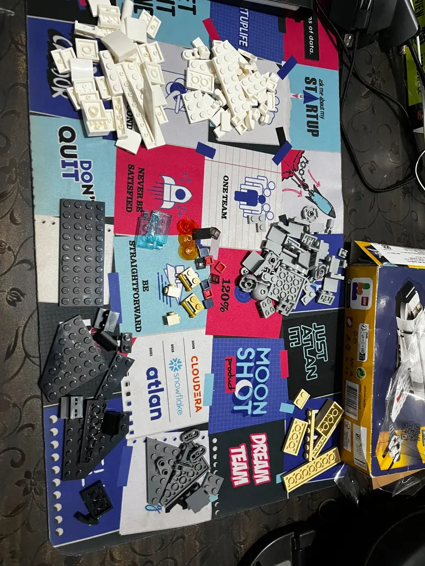 Collection of Lego pieces on colorful mat with motivational phrases